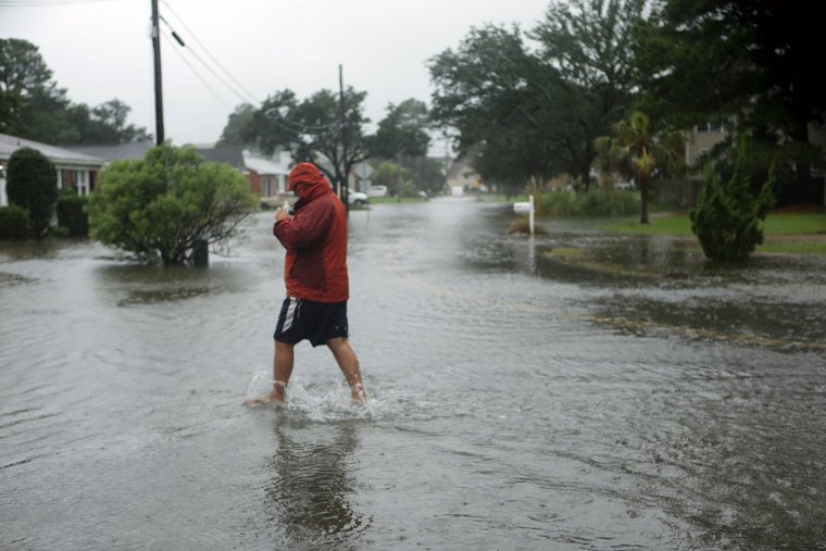 On foot is the best way to make it through the rising water on Lynnhaven Drive in Virginia Beach on Friday, Oct. 2, 2015. (Vicki Cronis-Nohe | The Virginian-Pilot) 