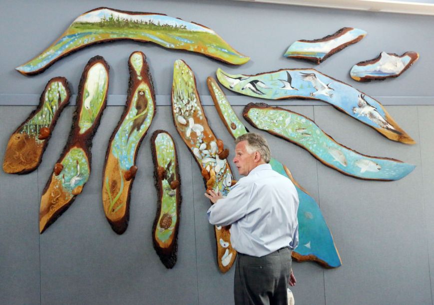 Gov. Terry McAuliffe looks at art made of a live oak tree during a tour . . . Photo Credit: Steve Early | Virginian-Pilot